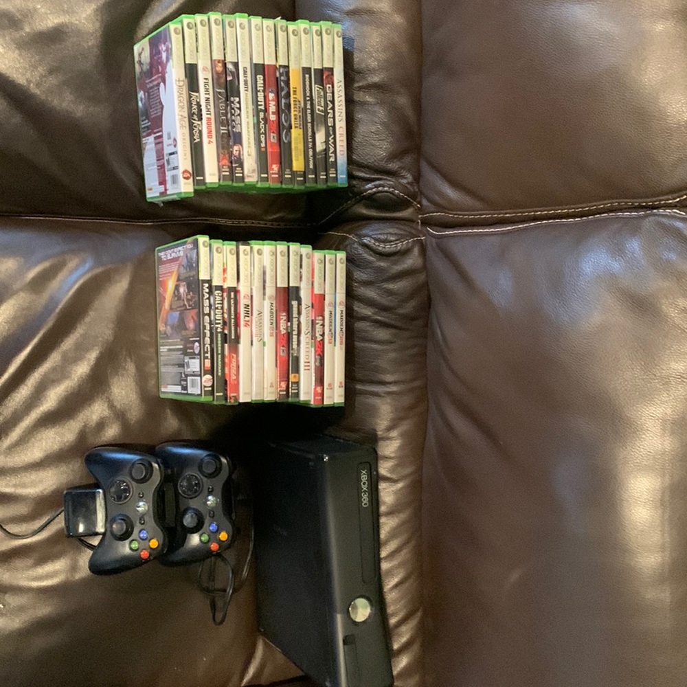 Xbox 360 with 2 controllers, charger, and 26 games.